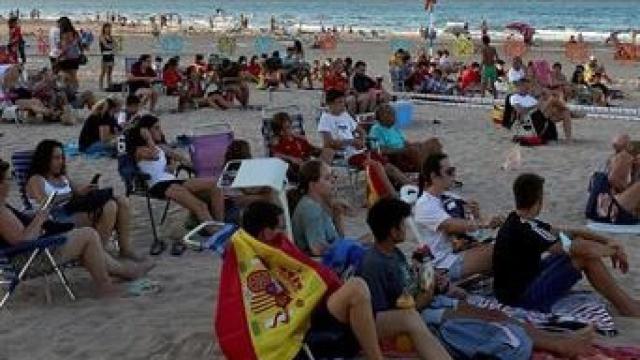 Aficionados de la selección española, durante el partido contra Italia en una playa de Gandía.